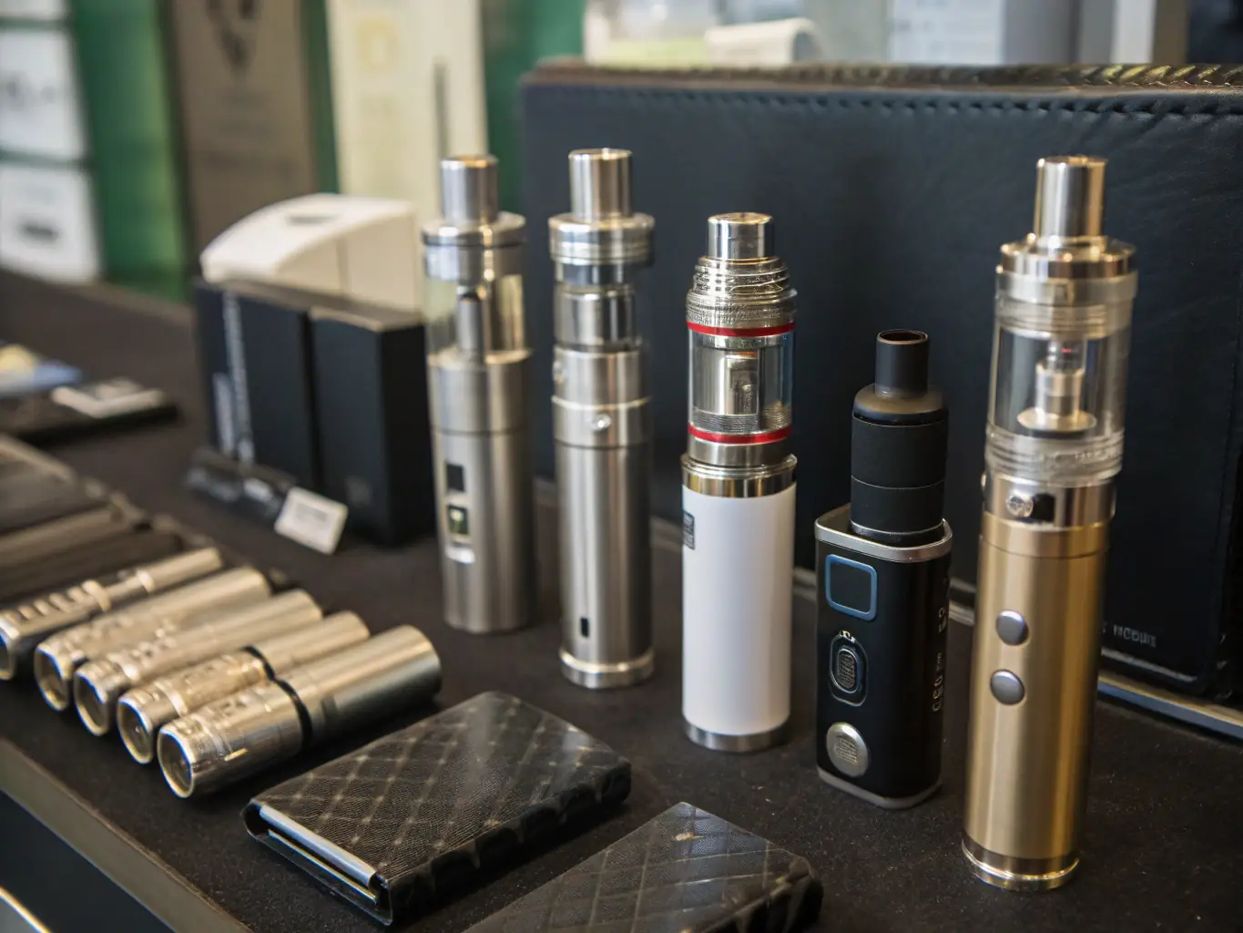 An assortment of vape accessories, including coils, tanks, batteries, and chargers, neatly organized to showcase the essential components for vaping.